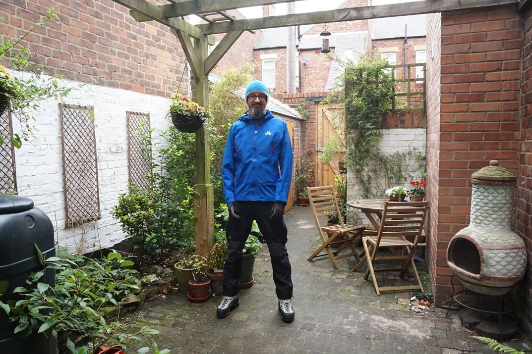 Man standing in garden in waterproof jacket